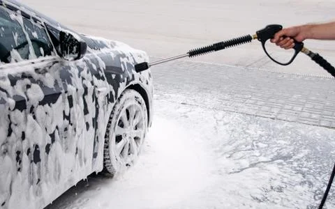 Gray car washed at the sink through a foam gun Stock Photos
