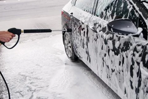 Gray car washed at the sink through a foam gun Stock Photos