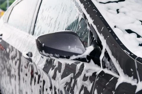 Gray car washes in soap from a detergent Stock Photos
