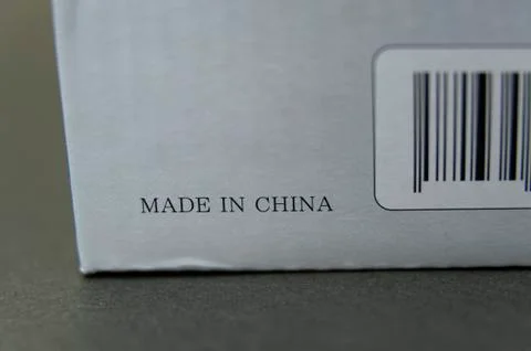 Gray cardboard box with bar code written: MADE IN CHINA. Stock Photos