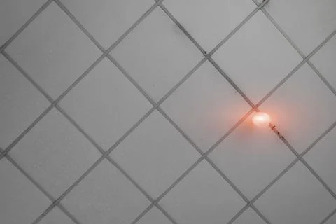 Gray ceiling with orange light bulbs..The roof of the house has a pattern. Stock Photos