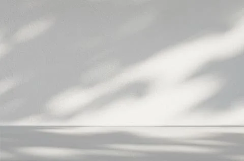 Gray cement background in empty room with light and shadow. Stock Photos