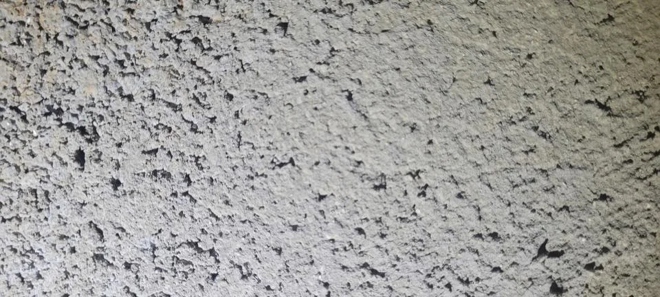 Gray cement plaster texture with coarse porous finish. Natural wall surface.. Stock Photos