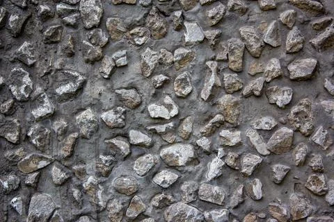 Gray Cement wall background textured with stone chips. Concrete wall of a Stock Photos