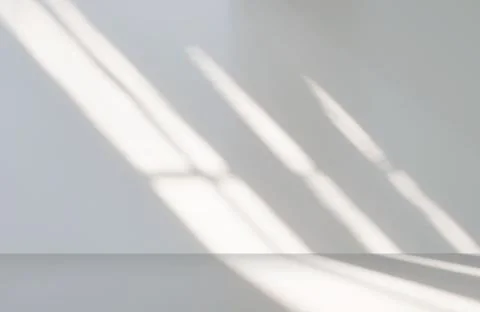 Gray cement wall in empty room with light and shadow. Stock Photos