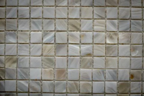 Gray ceramic mosaic on the wall as background Stock Photos