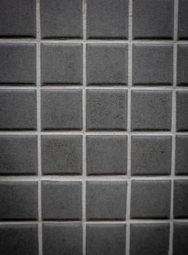 Gray ceramic mosaic on the wall as background Stock Photos