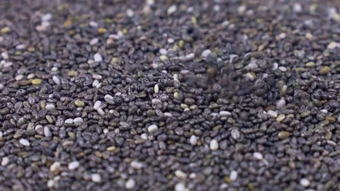 Gray chia seeds falling down close up Stock Footage 268850364
