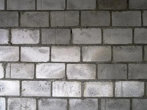 Gray Cinder Block Wall Displaying Variation in Texture and Tone Stock Photos