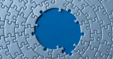Gray circular puzzles, pieces are disassembling on blue background. Empty tem Stock Footage 146908659