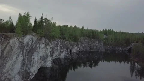 Gray cliff, green forest and blue lake. Video stock 149108478