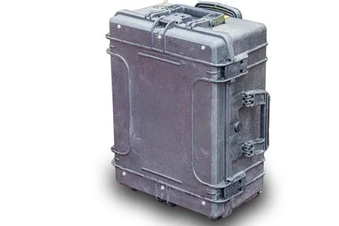 Gray, closed rectangular case with handle, against light background, sturdy a Foto stock