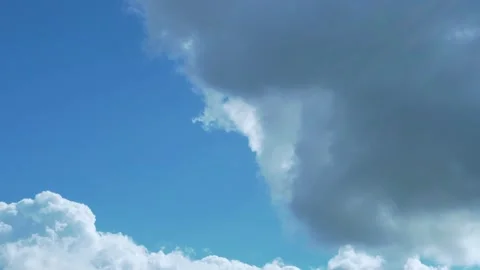 A Gray Cloud Flies Away Revealing A Heavenly Blue Sky in The Rays Of The Sun wit Stock Footage 160261442