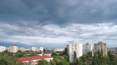 Gray clouds after a storm, above city buildings. Time lapse in residential area Stock Footage 155817787