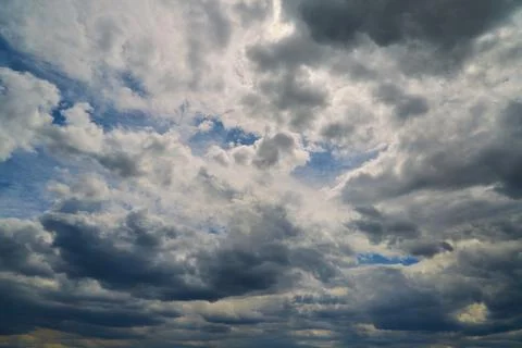 Gray clouds in blue sky close-up, cluster of clouds blocking sunlight Stock Photos
