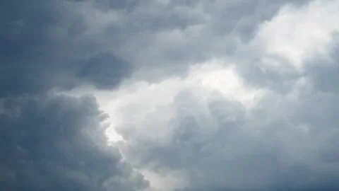 Gray clouds fill the sky as they gather thickly. The storm approaches steadily Stock Footage 335533726