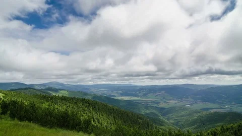 Gray clouds flying over beautiful green landscape time lapse Stock Footage 69781324