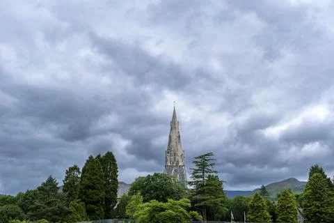 Gray clouds loom above ancient stone spire Stock Photos