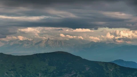 Gray clouds moving over alpine mountains in summer evening landscape Time lapse Stock Footage 108740510