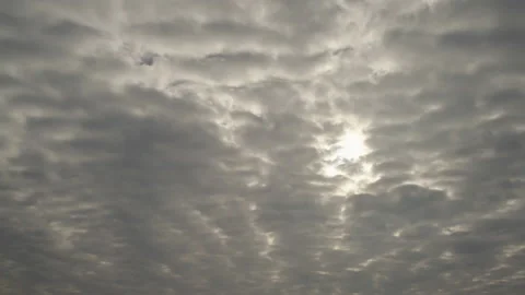 Gray clouds obscuring the entire sky quickly sweep into the distance beyond the Stock Footage 225309763