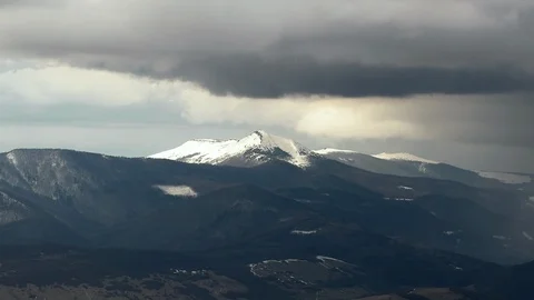 Gray clouds passing over the snowed mountains and forest Stock Footage 87248781