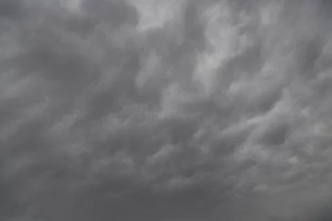 Gray clouds in the sky, storm clouds covering the sky, dramatic sky in gray l Stock Photos