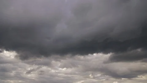 Gray clouds in stormy sky while overcast weather. Thunderstorm sky before rain Stock Footage