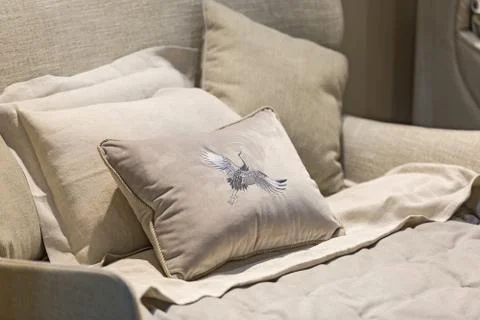 Gray color pillows setting on bed with velor finished style bedding. Pillow w Stock Photos