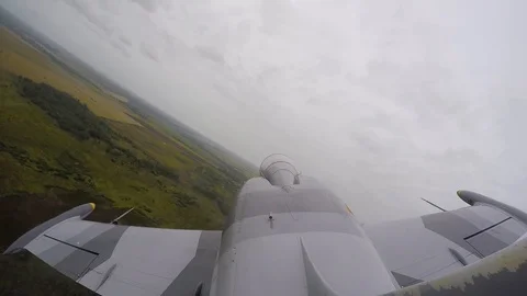 Gray combat jet fly over field and rolls. Top view from the tail fin close up. Stock Footage 118677476