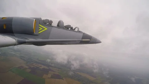 Gray combat jet plane make Split S maneuver. Dangerous trick. View from wing. Stock Footage 118676558