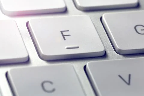 Gray computer keyboard seen in extreme close-up with the letters on the tuches Stock Photos