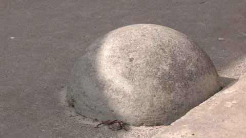 Gray concrete anti-parking hemispheres at the sidewalk. Video stock 244971853