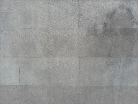 Gray concrete background with rectangular lines and a black spot on the right Stock Photos