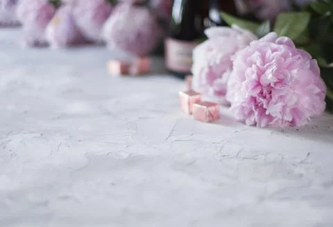 Gray concrete background with selective focus,a bouquet of pink peonies,in blur Stock Photos