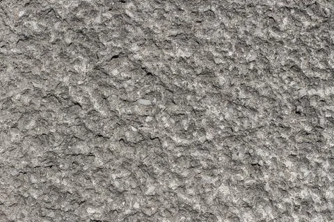 Gray concrete backgroundl with small white stones. Texture or background. Stock Photos