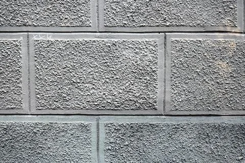 Gray concrete block wall texture with rough surface and vertical lines Stock-Fotos