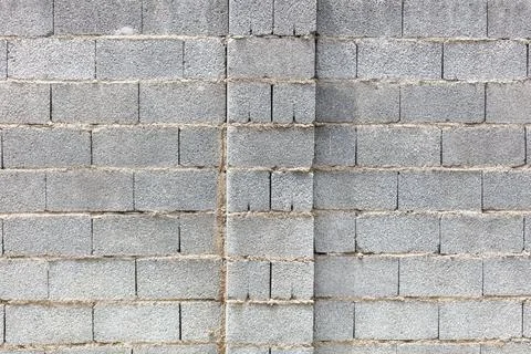 Gray concrete blocks form a textured wall Stock Photos