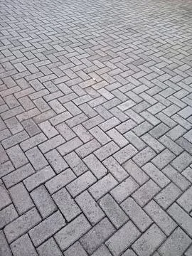 Gray concrete brick pavement in herringbone pattern, outdoor walkway textur.. 写真素材