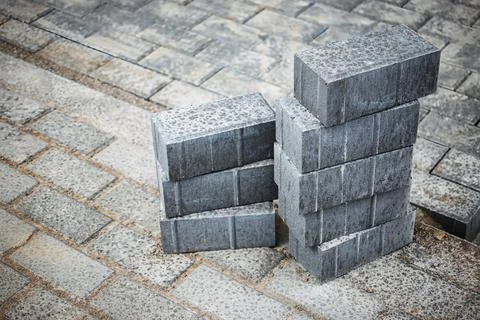 Gray concrete bricks are stacked in a construction area, showcasing a texture 写真素材