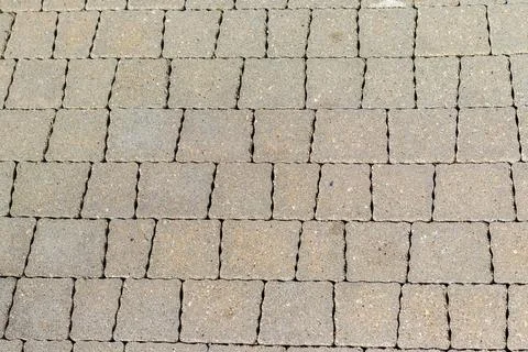 Gray concrete paving slabs texture background on a sidewalk. Texture Stock Photos