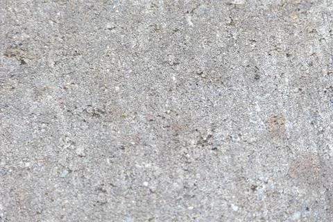 Gray concrete surface showing a rough and gritty texture with visible aggrega Stock Photos