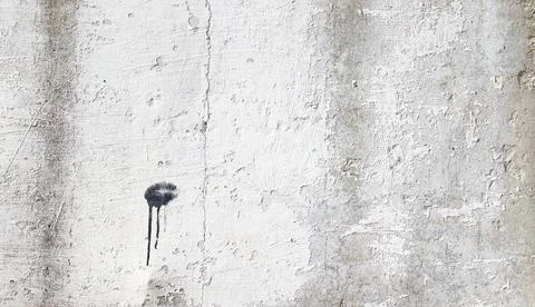 Gray concrete wall with cracks in the old whitewash. Stock Photos