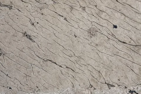 Gray concrete wall with cracks. rough surface texture Stock Photos