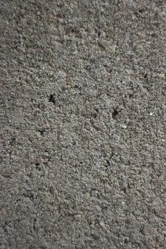 A gray concrete wall made of small stone chips. 库存照片