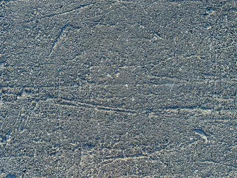 Gray concrete wall texture with strong dents Stock Photos
