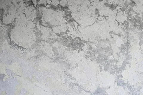 A gray concrete wall with a vertical lighting gradient interspersed with whit Stock Photos