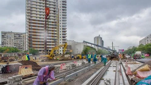 Gray construction telescopic crane unloading tram rails from truck timelapse. Stock Photos