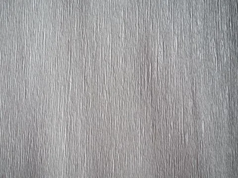 Gray corrugated paper. Uneven surface. Abstract background. Wavy edges of the Stock Illustration