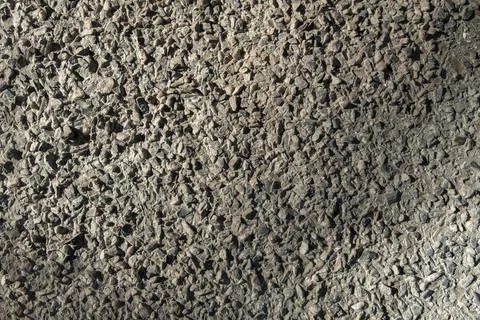 Gray crushed stone with shadows. rough surface texture Stock Photos