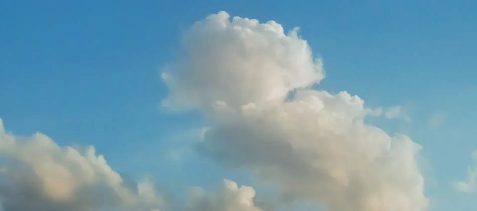 Gray Cumulus clouds in a blue sky Stock Photos